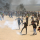 Palestinian protesters burn tires near the Israeli border fence, east of Khan Younis, in the Gaza Strip on May 14, 2018.